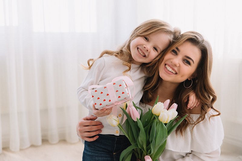 happy-mother-s-day-child-daughter-congratulates-moms-gives-her-flowers-tulips-gift.jpg